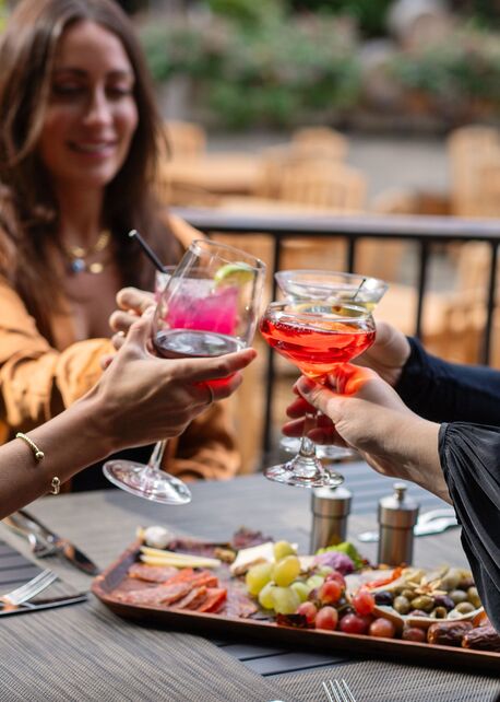 Guests toasting cocktails over a charcuterie board at Americana House happy hour, Appellation Lodi in Lodi wine country