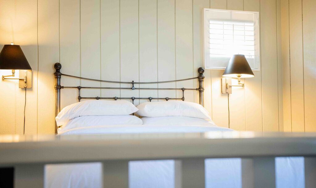 One-bedroom loft suite with an iron bed at Appellation Lodi - Wine & Roses Resort and Spa