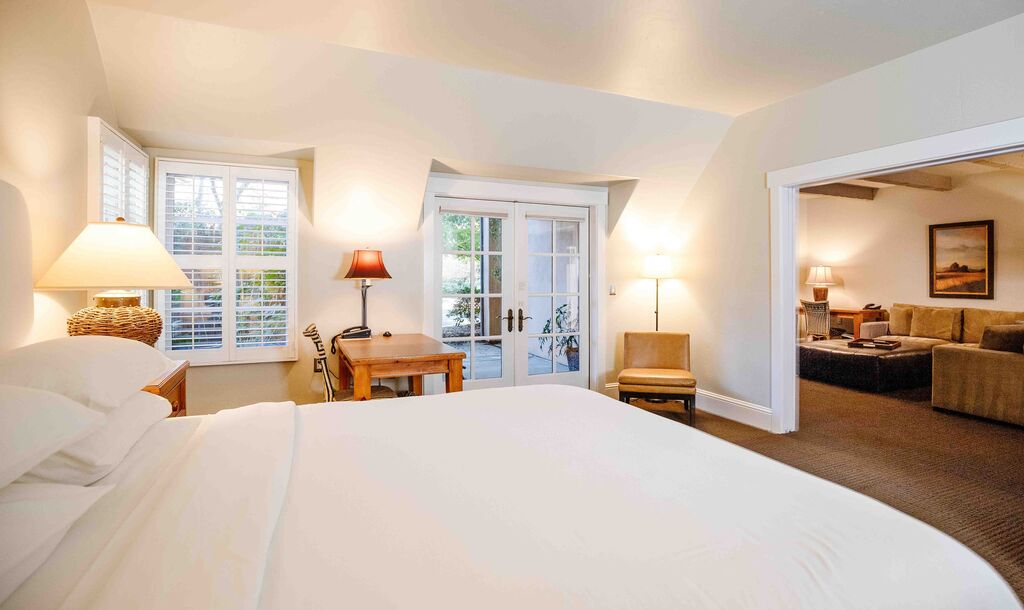 Junior suite king bedroom opening to a sitting room at Appellation Lodi - Wine & Roses Resort and Spa